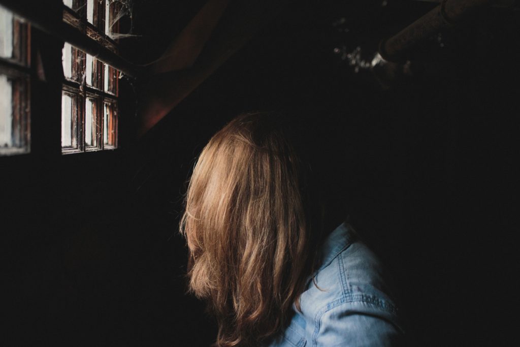 Woman with head bowed